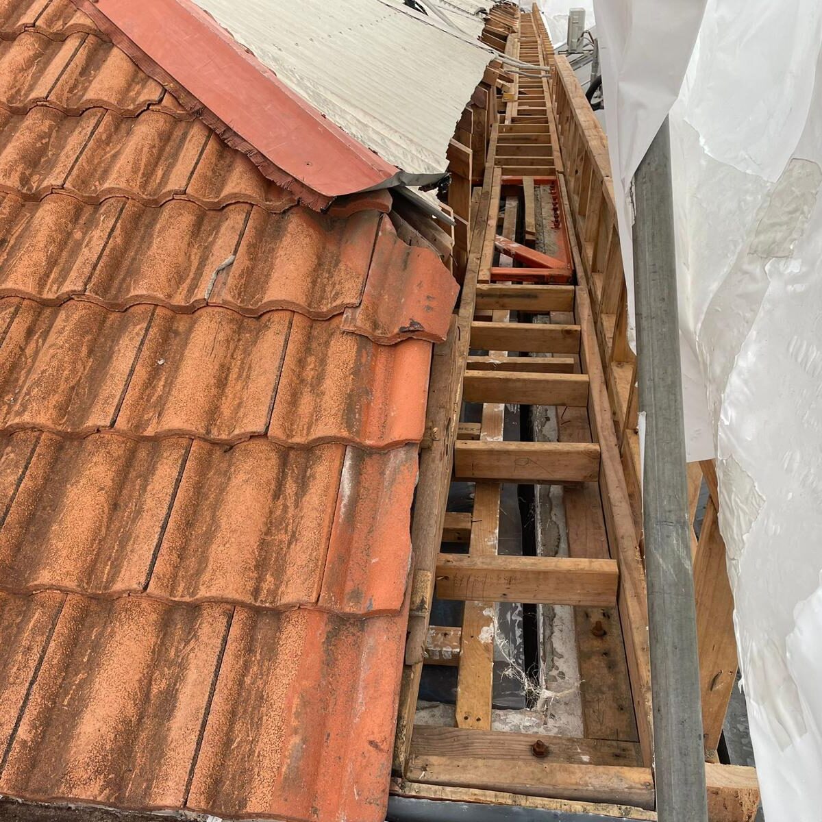 Roof after asbestos removed, clear for roofer to begin work.